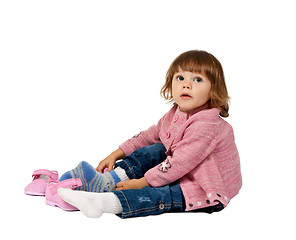 Image showing little girl wears shoes on a white floor