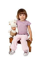 Image showing little girl sitting on a wooden stool