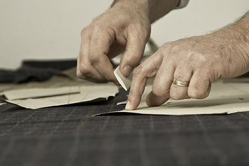 Image showing detail of tailor's hand with chalk