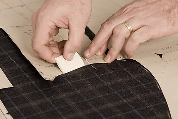 Image showing detail of tailor's hand with chalk
