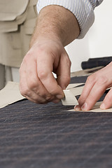 Image showing detail of tailor's hand with chalk