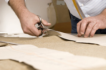 Image showing detail of tailor's hand with scissors