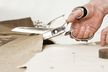 Image showing detail of tailor's hand with scissors