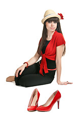 Image showing Beautiful girl on the background of a pair of red women's shoes.