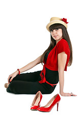 Image showing Beautiful girl on the background of a pair of red women's shoes.