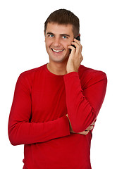 Image showing man in a red dress speaks on a mobile phone.