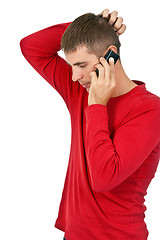 Image showing man in a red dress speaks on a mobile phone.