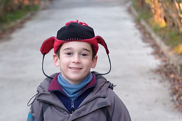 Image showing Cute little boy head in a funny hat outdoor in autumn