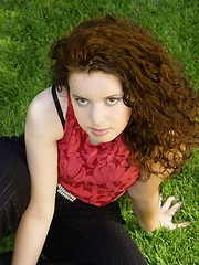 Image showing Beautiful girl sitting on the grass