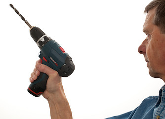 Image showing Senior man holding a power drill