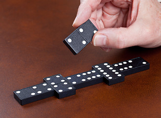 Image showing Game of dominoes on leather table