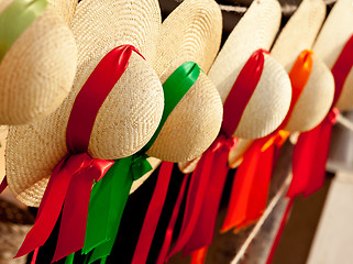 Image showing Row of straw hats with ribbons