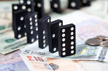 Image showing Standing dominoes on bank notes