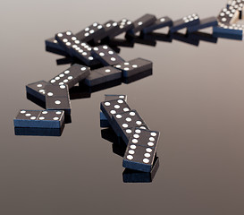 Image showing Dominoes collapsed on reflective surface