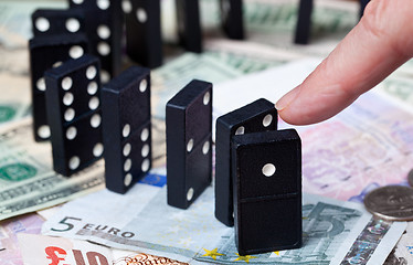 Image showing Standing dominoes on bank notes