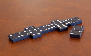 Image showing Game of dominoes on leather table