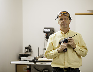 Image showing Senior man holding power drill