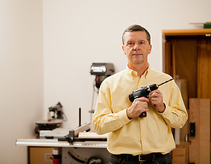 Image showing Senior man holding power drill