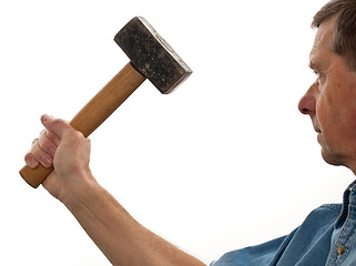 Image showing Senior man holding a large hammer