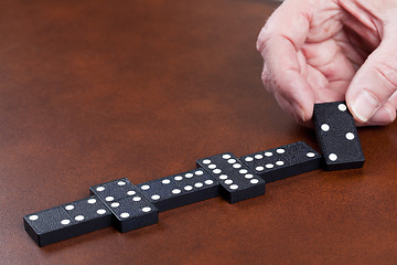 Image showing Game of dominoes on leather table