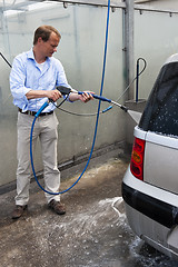 Image showing Washing a car