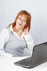 Image showing tired girl with a laptop