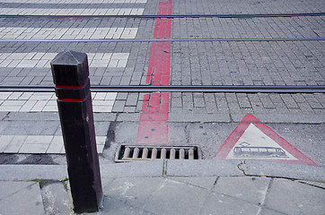 Image showing Sidewalk and tram rails. Warning sign street.