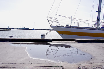 Image showing Yacht resting moored at port. Seagull and pier.