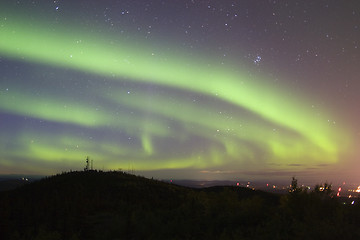 Image showing Aurora swirling over town