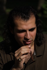 Image showing Person Smoking a Cigar