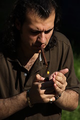 Image showing Person Smoking a Cigar