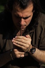 Image showing Person Smoking a Cigar