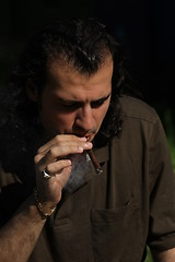 Image showing Person Smoking a Cigar