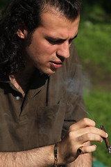 Image showing Person Smoking a Cigar