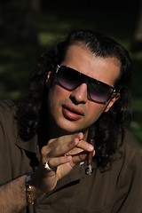 Image showing Person Smoking a Cigar