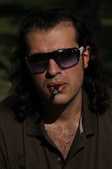 Image showing Person Smoking a Cigar