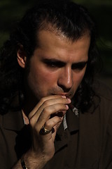 Image showing Person Smoking a Cigar