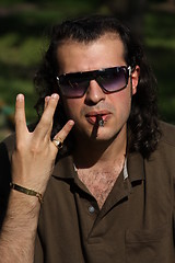 Image showing Person Smoking a Cigar