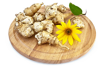 Image showing Jerusalem artichoke with a yellow flower on a round board