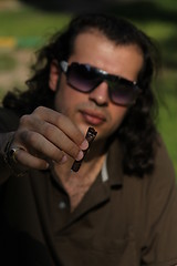 Image showing Person Smoking a Cigar