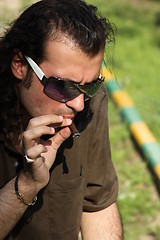 Image showing Person Smoking a Cigar