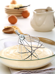 Image showing Vanilny sauce in a bowl and whisk for whipping.