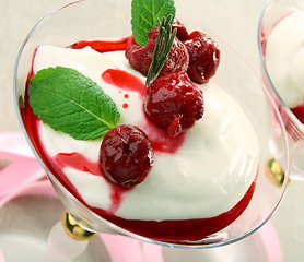 Image showing Yoghurt panna cotta with cherry sauce in a glass goblet.