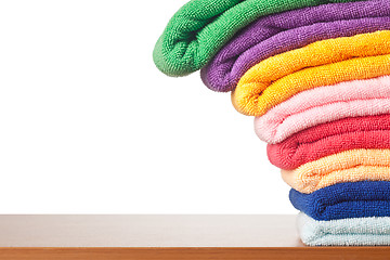 Image showing Stack of colorful microfiber towels toppling