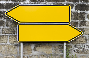 Image showing direction signs with wall in background