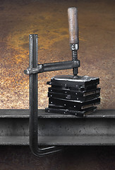 Image showing pressing stack of hard drives with a clamp