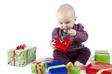 Image showing young child unpacking presents