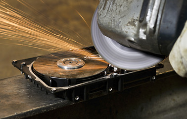 Image showing working with angular grinder on open hard drive