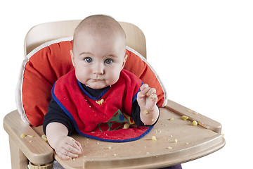 Image showing toddler eating potatoes