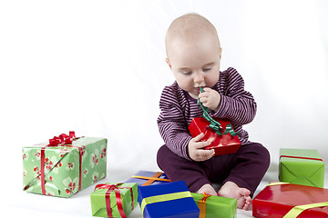 Image showing young child unpacking presents